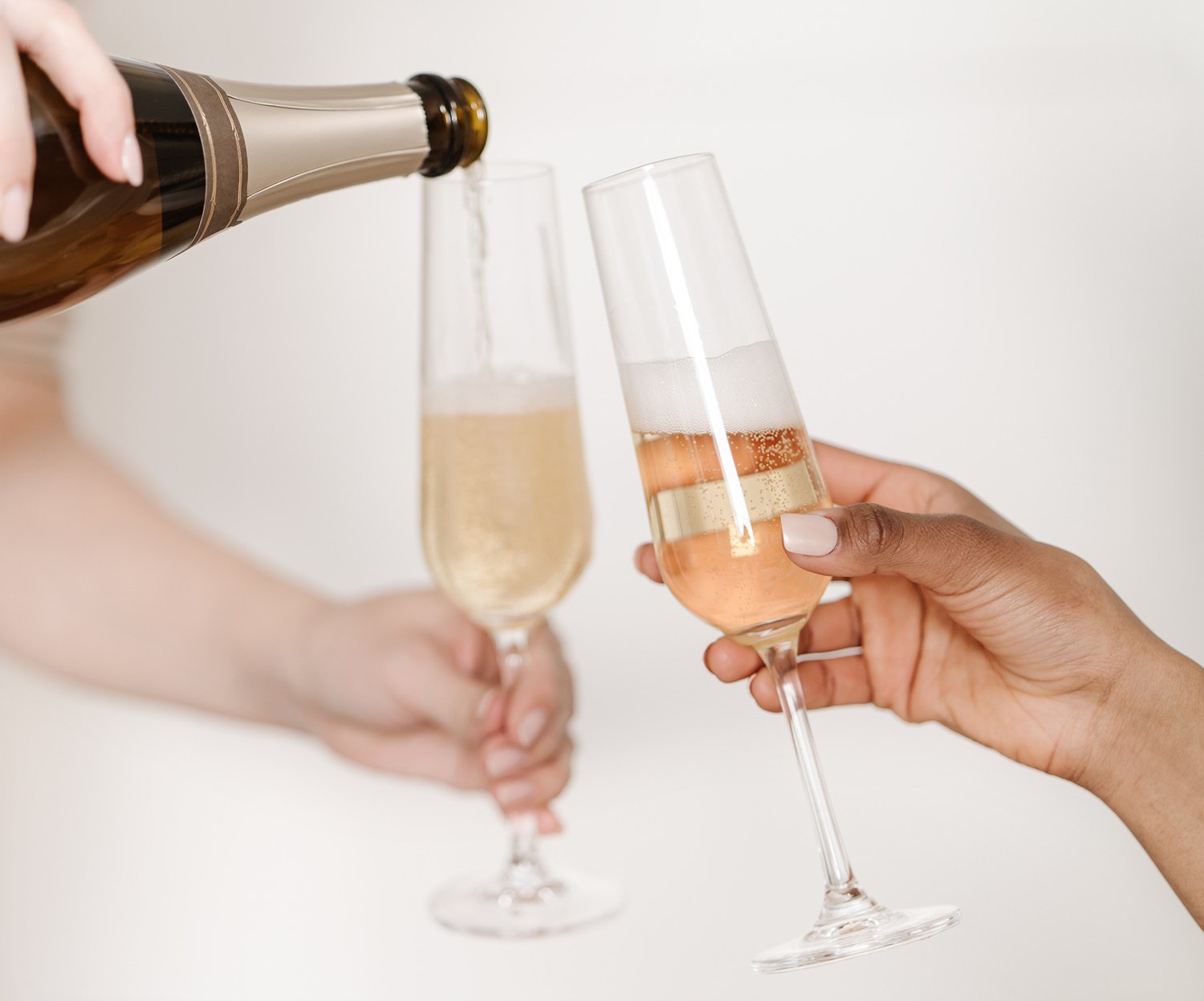 two people filling champagne glasses as they celebrate how much work they have to do to rank well on Google